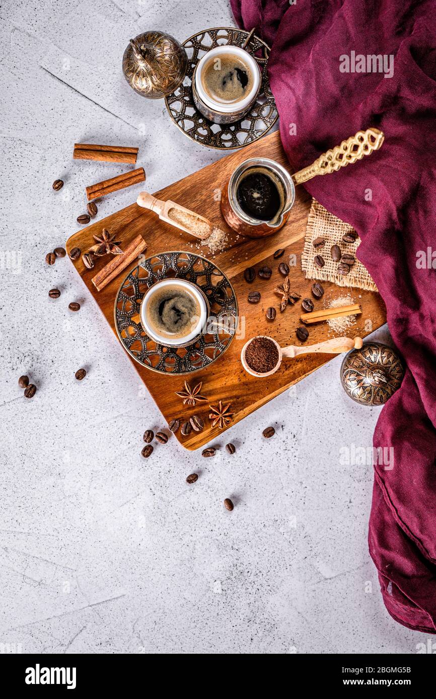 White coffee table with coffee beans, ground powder and spices. Arabic traditional styled coffee Stock Photo