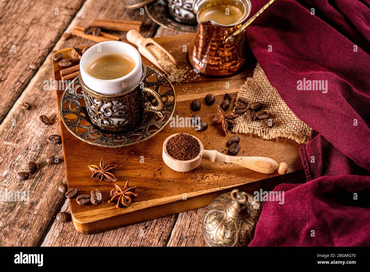 Detail of a cup of coffee and coffee beans on wood background Stock Photo