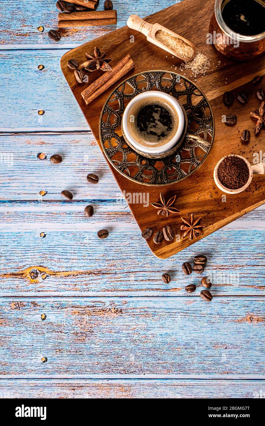Coffee cup, beans and spices on old kitchen table. Top view with copyspace for your text Stock Photo