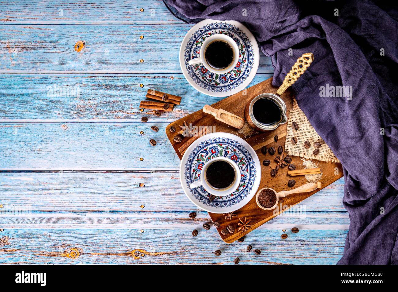 Ground coffee and coffee cups turkish style on blue background Stock Photo