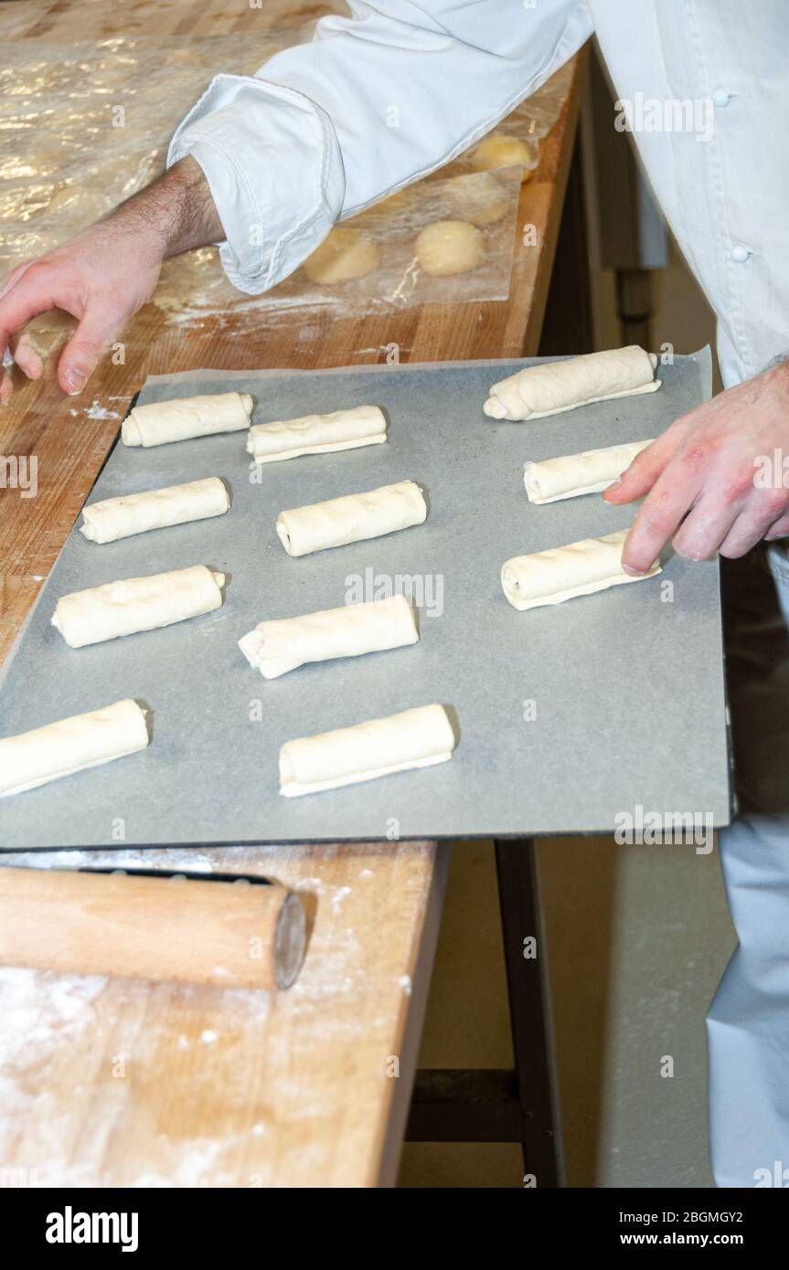 Baker preparing chocolate croissant Stock Photo