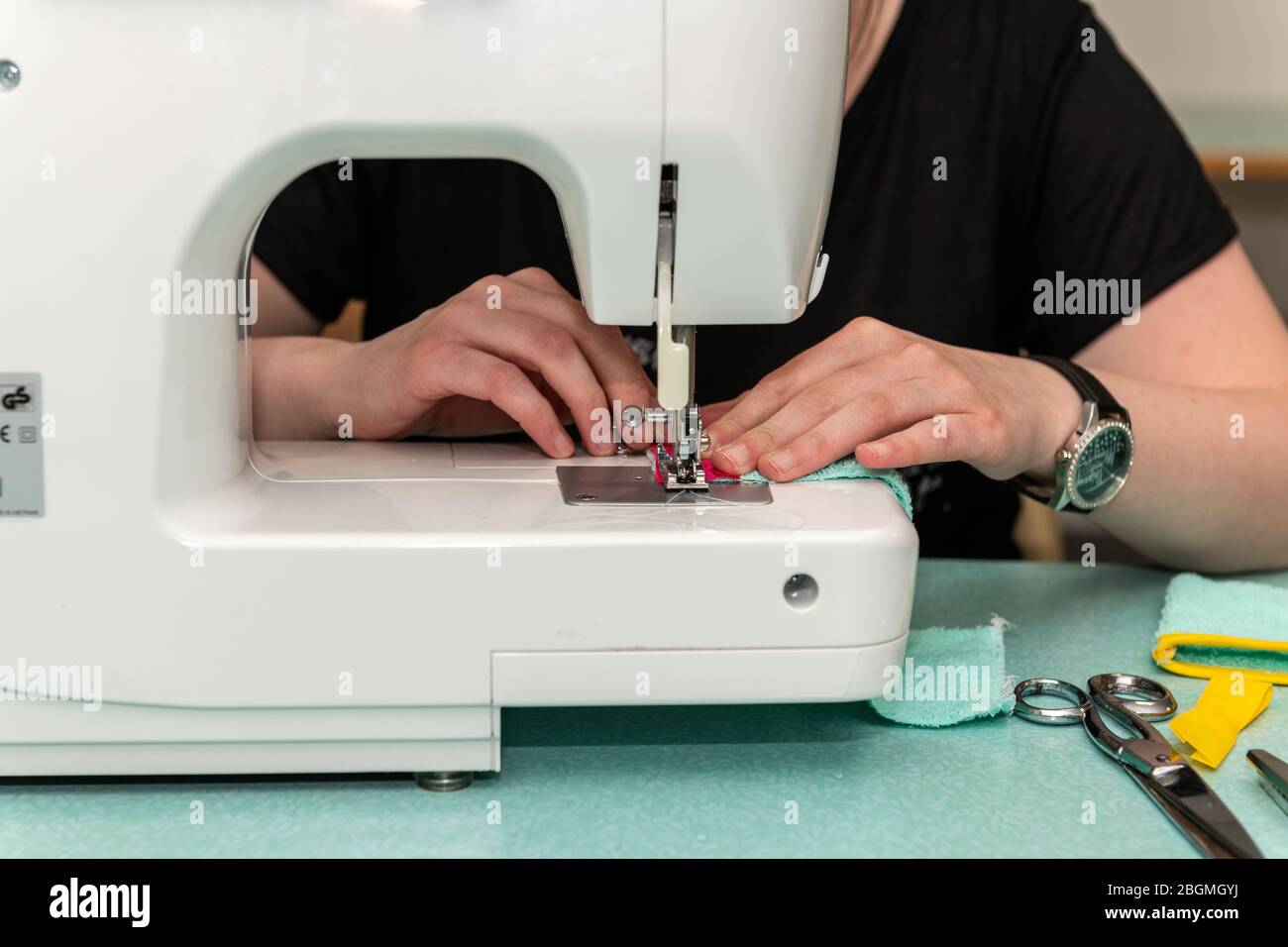 Woman sewing using a sewing machine Stock Photo Alamy