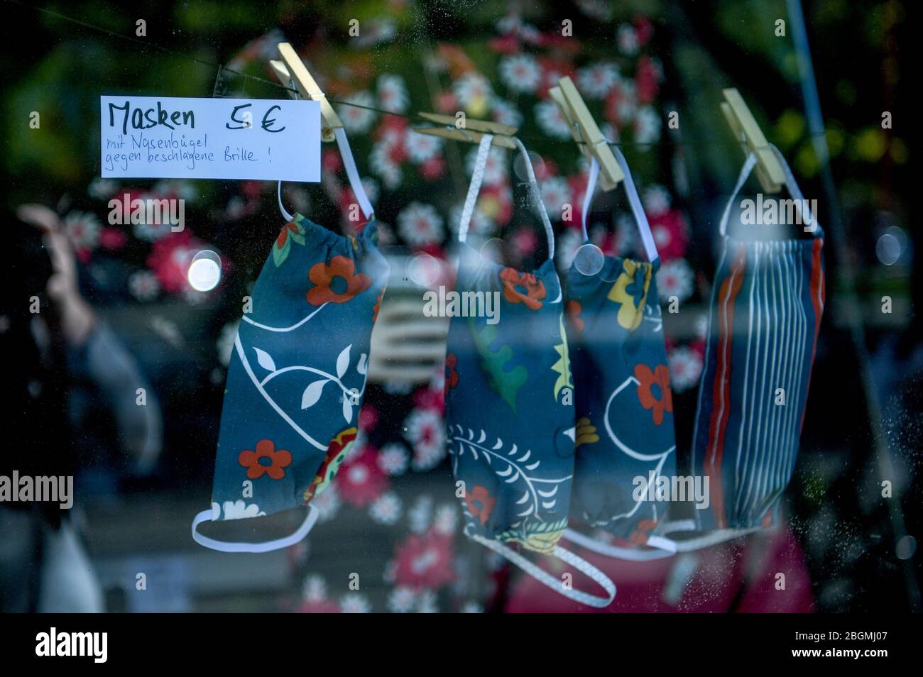 Berlin, Germany. 22nd Apr, 2020. A shop offers nose-mouth protection for sale in the shop window. Credit: Bernd von Jutrczenka/dpa/Alamy Live News Stock Photo