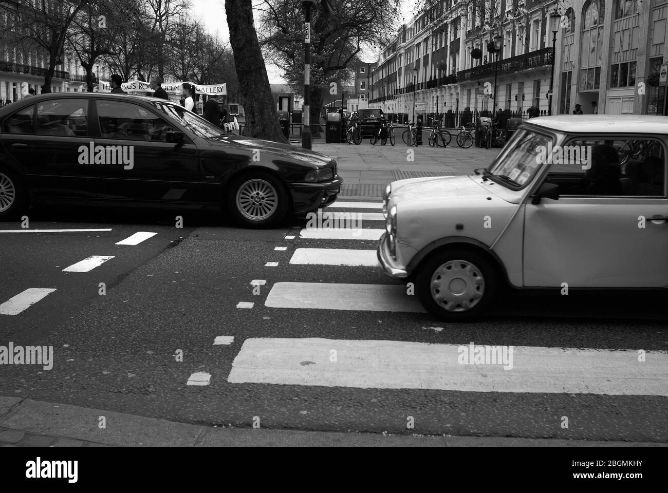 Mini and a Jag on a zebra crossing, King’s Road,Chelsea, London,SW3 Stock Photo