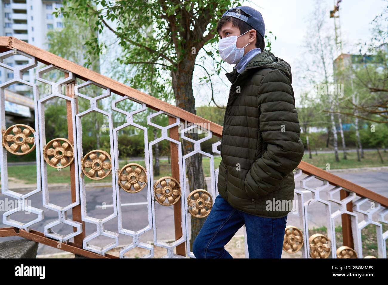 teen boy walks down the street during the day, a pedestrian walkway and ...