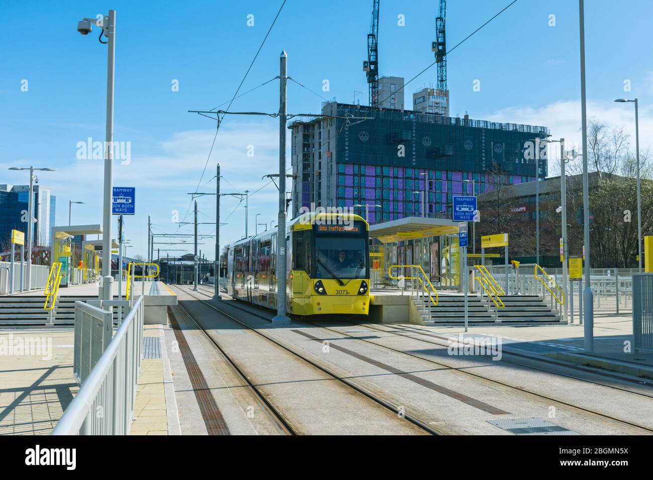 Metrolink tram at the Wharfside stop on the opening day of the Trafford Park Line, 22 March 2020.  Wharfside, Old Trafford, Manchester, UK Stock Photo