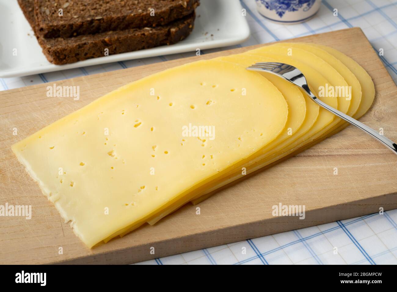 Slices of young Gouda cheese close up for breakfast Stock Photo