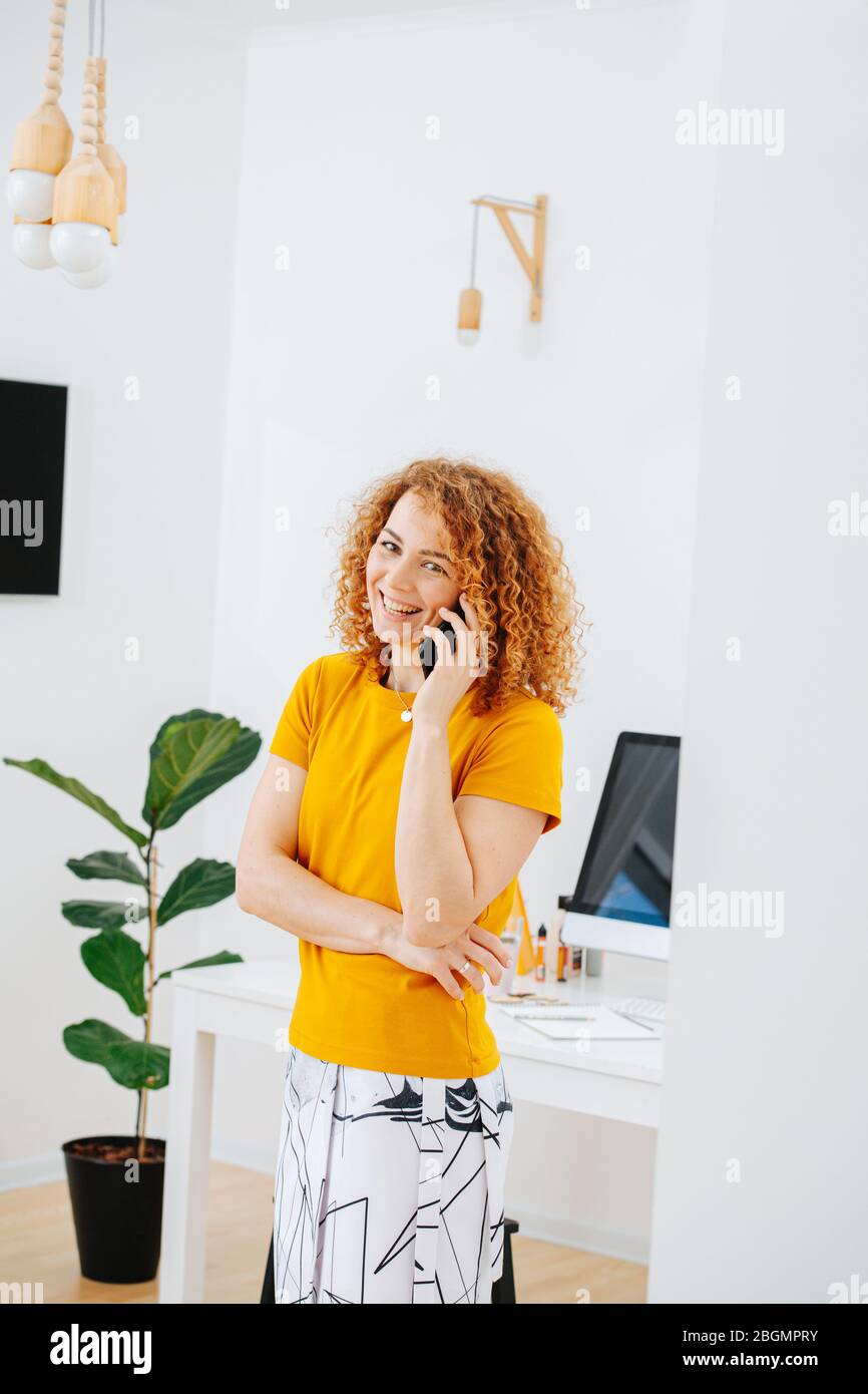 Chatty young woman hair talking on the phone, laughing Stock Photo