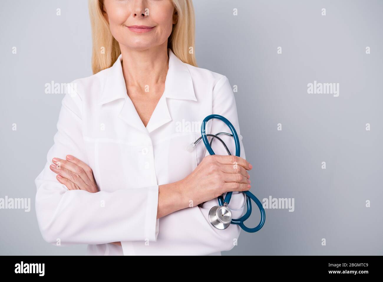 Cropped photo of professional infection specialist retired pensioner woman hold her stethoscope ready consult examine covid-19 infection pneumonia Stock Photo