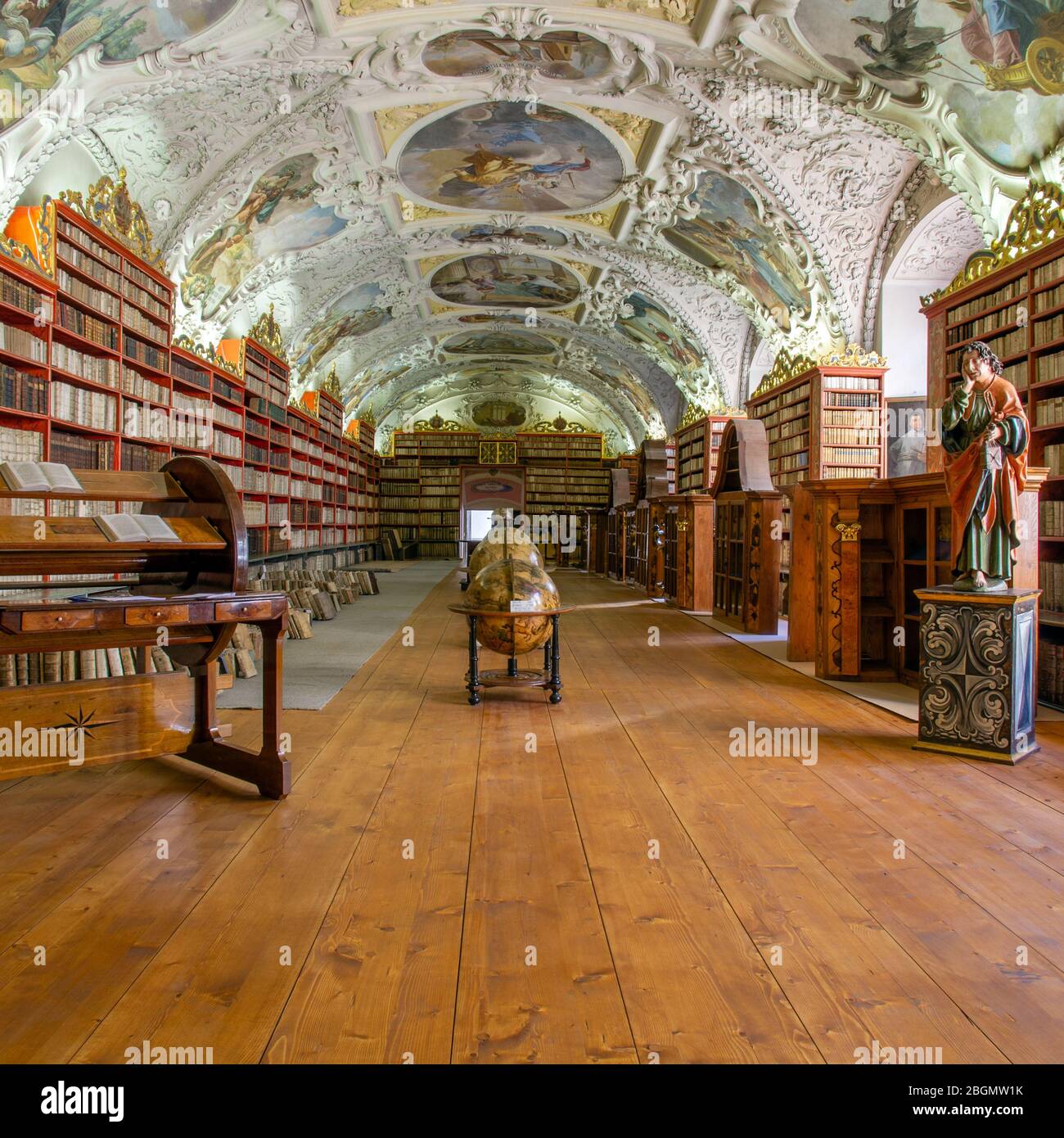 A view along the famous Reading Room in the Strahov Library, Prague. Ancient tomes line the walls under the ornately detailed ceiling. Stock Photo