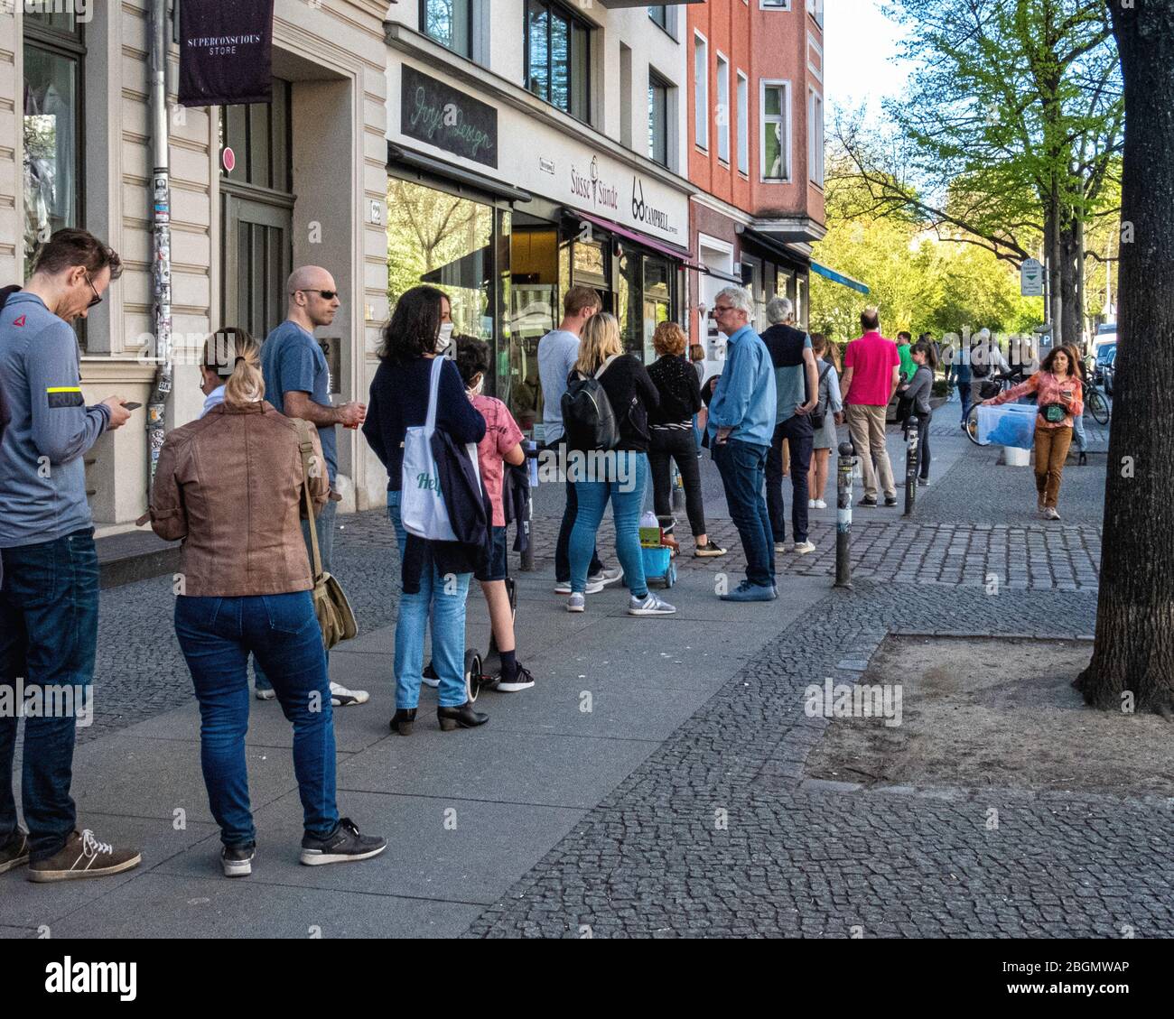 Berlin, Mitte, COVID-19 epidemic. People observe social distancing in queue outside  Süsse Sunde ice cream shop Stock Photo