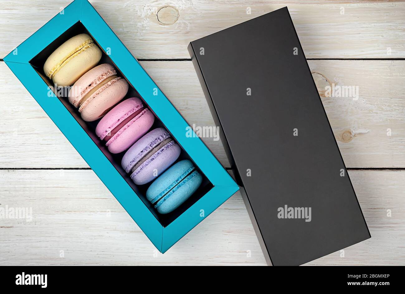 Macaroons in box next to lid Stock Photo