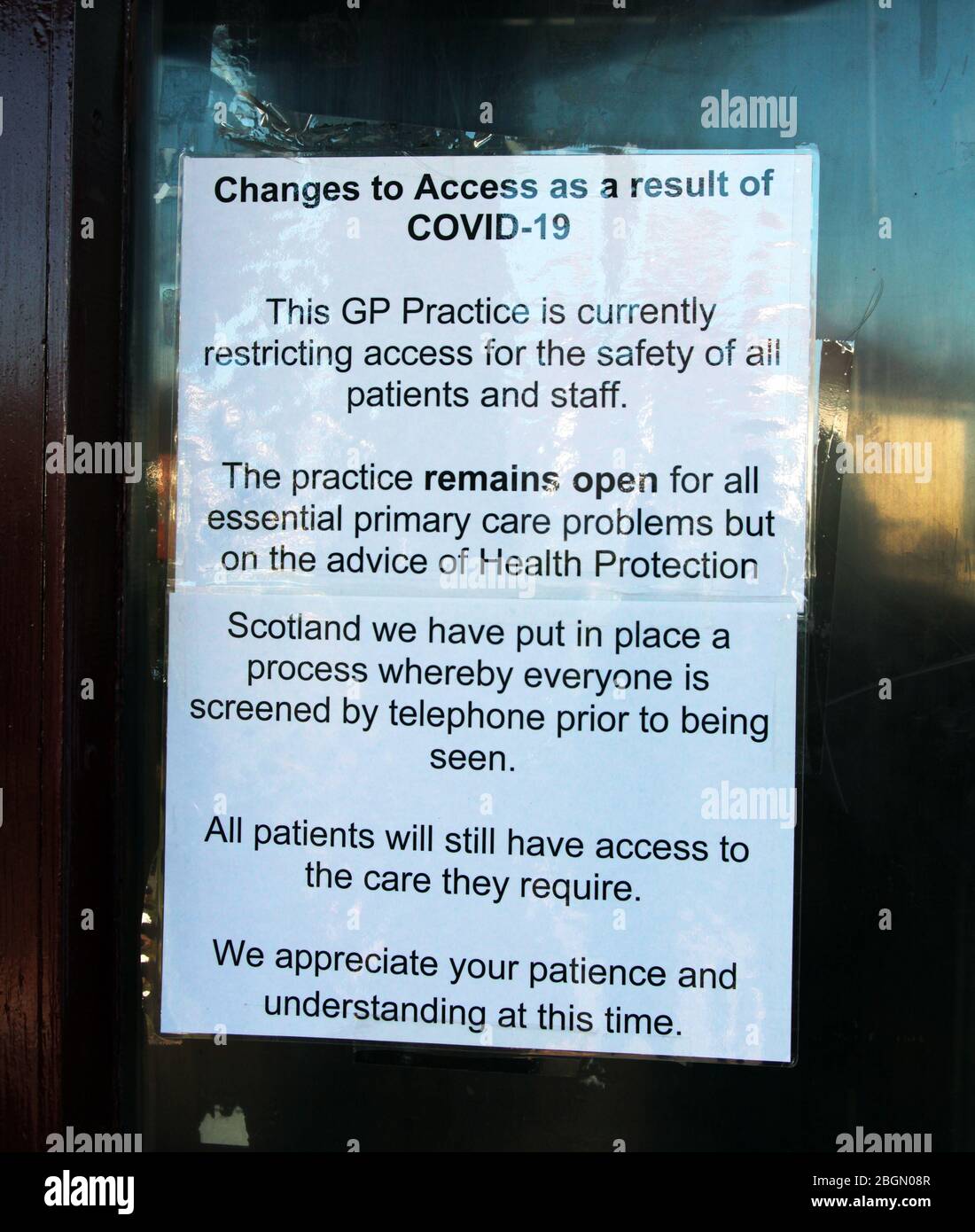A notice, on the door of a medical practice, advises patients that it s closed and patients cannot enter, but, should telephone instead. This precaution is because of the widespread nature of the Covid-19 and coronavirus that is rampaging through Britain. Glasgow. April 2020. ALAN WYLIE/ALAMY© Stock Photo