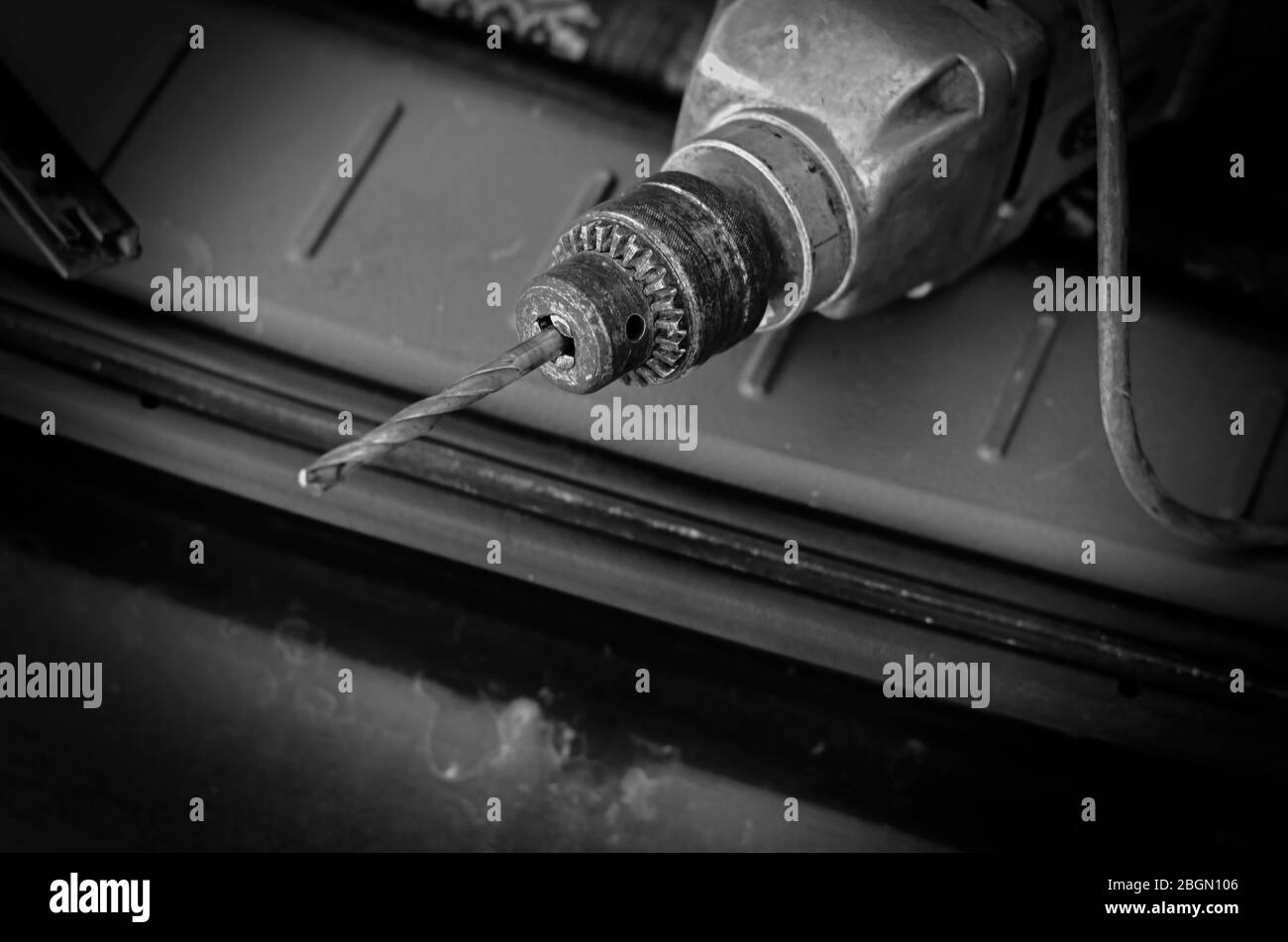 Old electric drill with a drill. Outdated electric drill with rusty cam