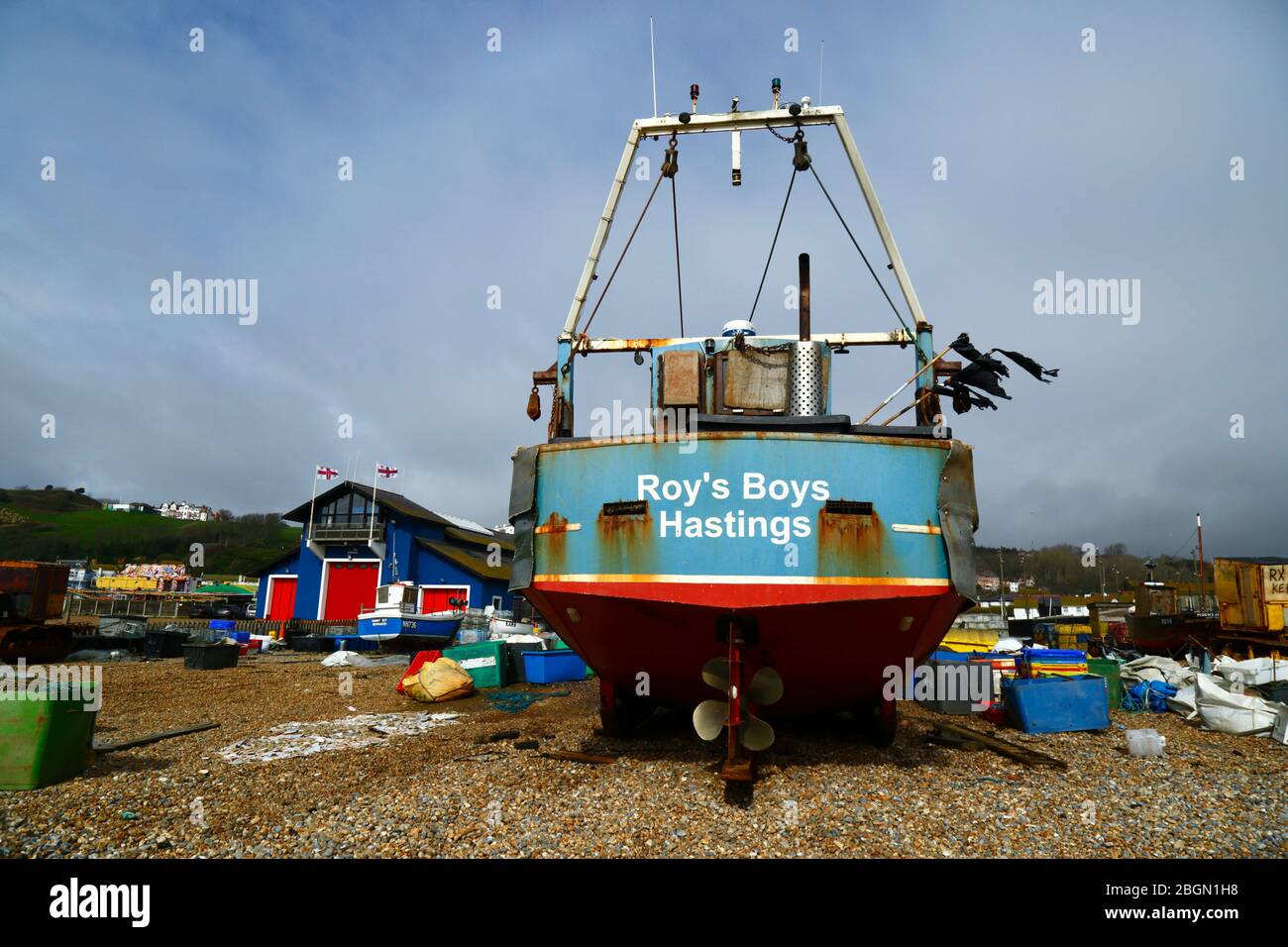 Roy's Boys fishing boat on The Stade shingle beach, lifeboat station in background, Hastings, East Sussex, England, UK Stock Photo