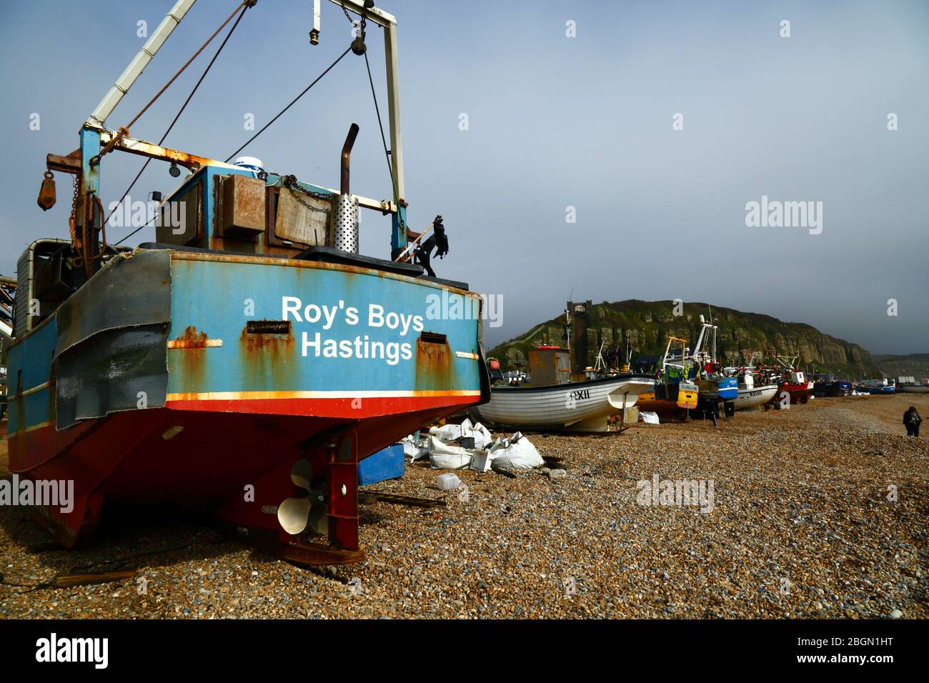 Roy's Boys fishing boat on The Stade  shingle beach below East Hill Cliff, Hastings, East Sussex, England, UK Stock Photo