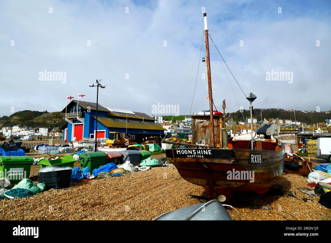 Fishing boat called Moonshine on The Stade shingle beach, lifeboat station in background, Hastings, East Sussex, England, UK Stock Photo