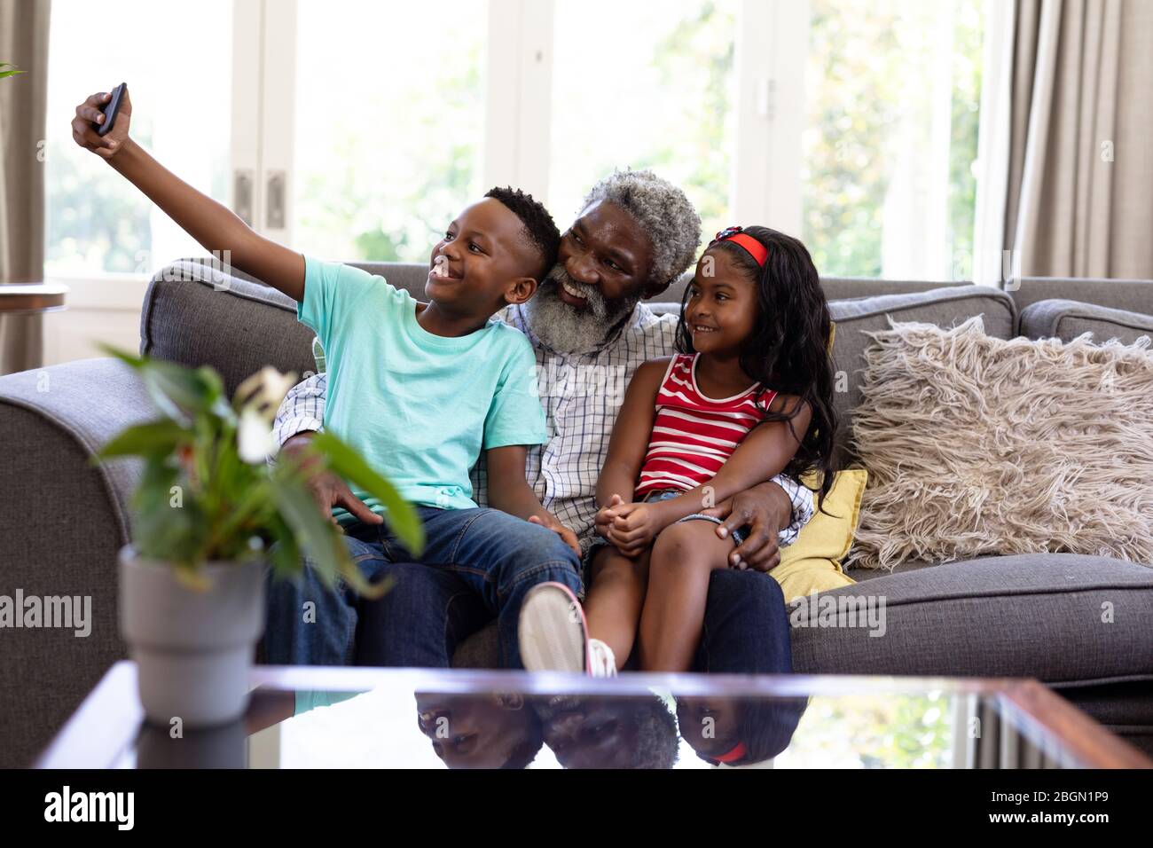Senior African American man and his grandchildren at home Stock Photo