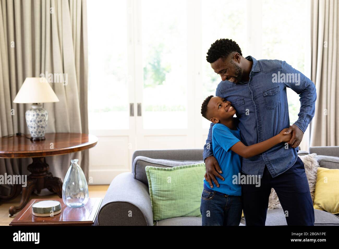 African American man enjoying his time at home With his son Stock Photo