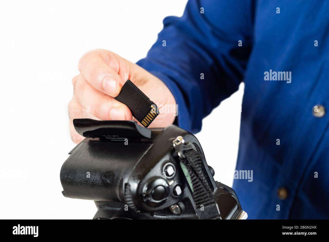 man inserting a memory card in a reflex camera Stock Photo