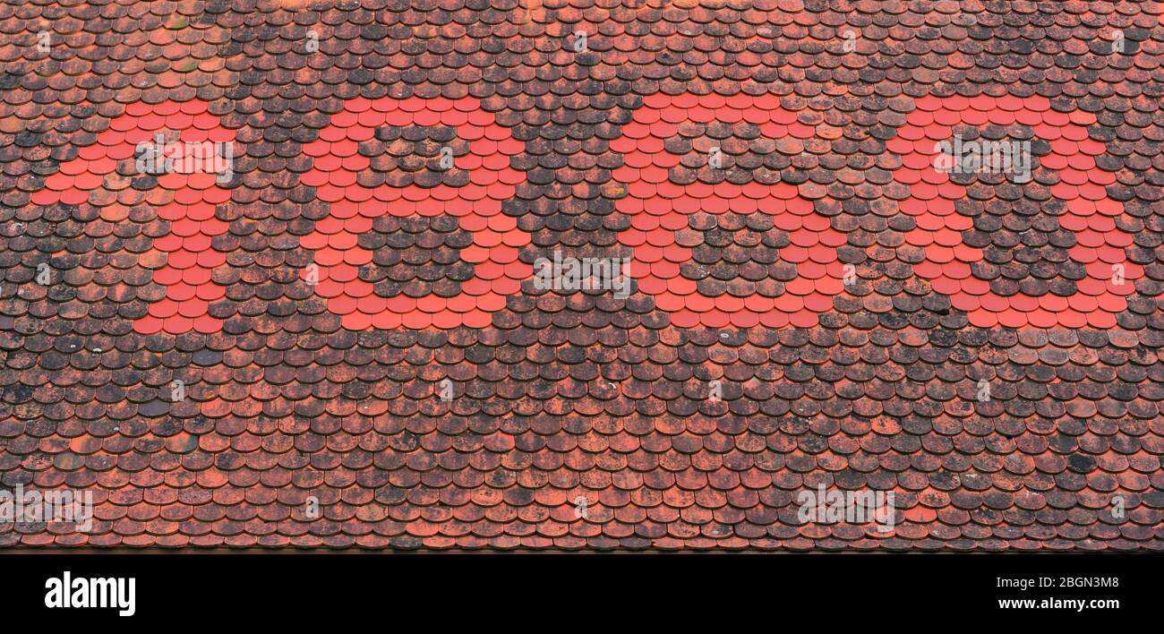 The number 1860 on the tiled roof of an old house, shown with red tiles Stock Photo