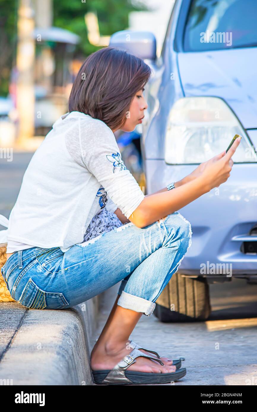 Woman sitting in a car and playing a Pokemon Go game Stock Photo - Alamy