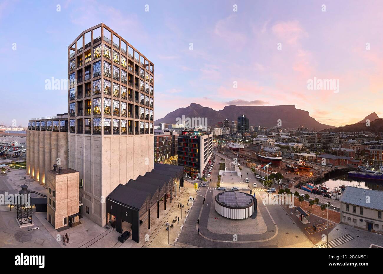 Elevated oblique view of exterior facade at dusk. Zeitz MOCAA, Cape Town, South Africa. Architect: Heatherwick Studio, 2017. Stock Photo