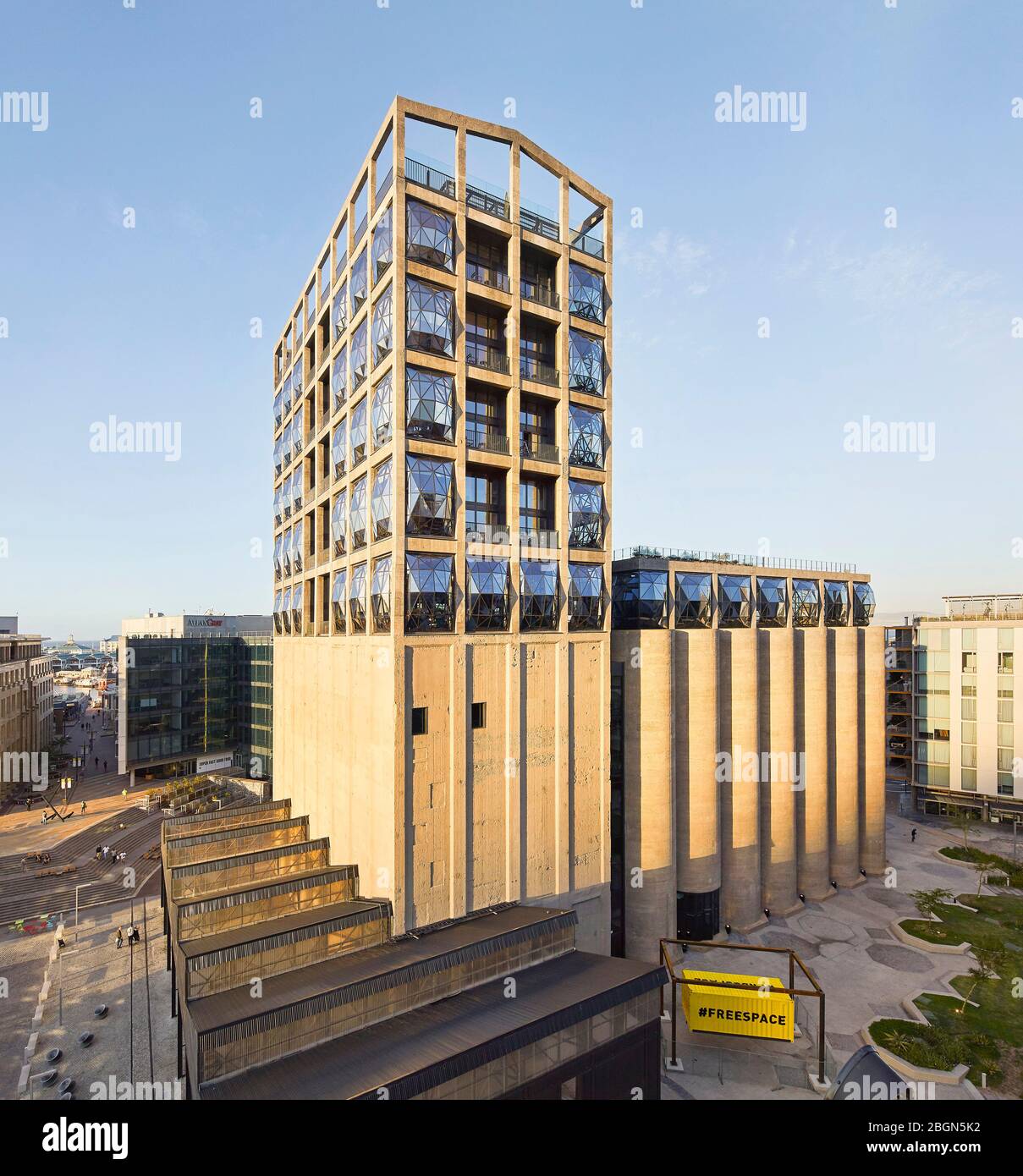 Exterior facade with elevated view of canopied Track Shed forecourt. Zeitz MOCAA, Cape Town, South Africa. Architect: Heatherwick Studio, 2017. Stock Photo