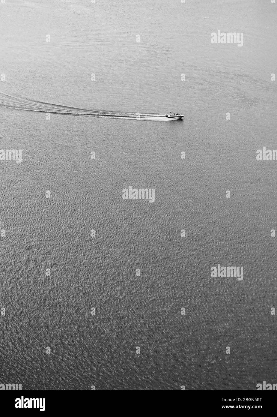 Aerial view of boat speeding along a lake Stock Photo