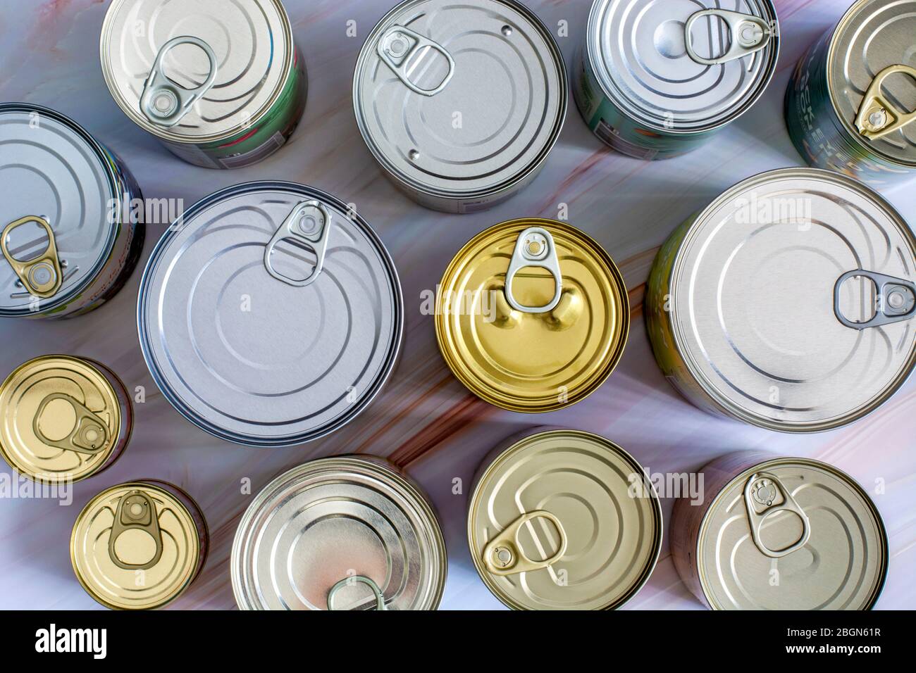 Overhead view row canned food in different sizes and colors. Stock non-perishable preserved food Stock Photo