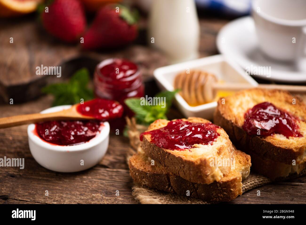 Fresh strawberry jam with bread for breakfast close up Stock Photo - Alamy