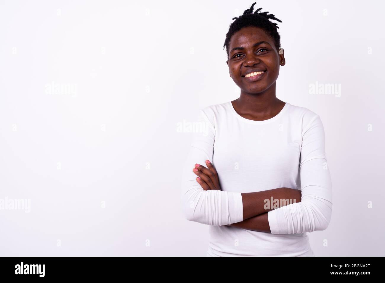 Portrait of happy young beautiful African woman smiling with arms ...