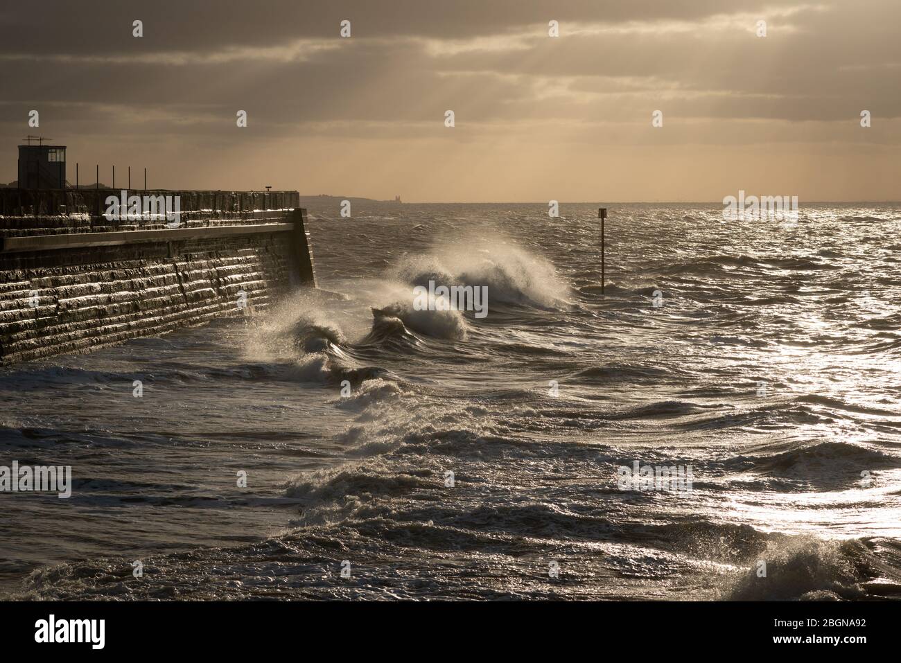 Stormy weather and crashing waves on the harbour arm in Margate, Kent Stock Photo