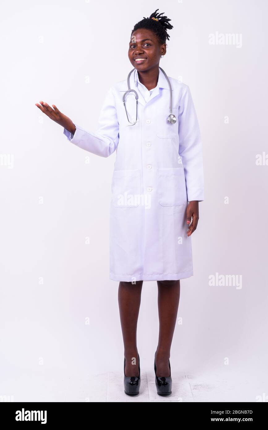 Full body shot of young beautiful African woman doctor Stock Photo - Alamy