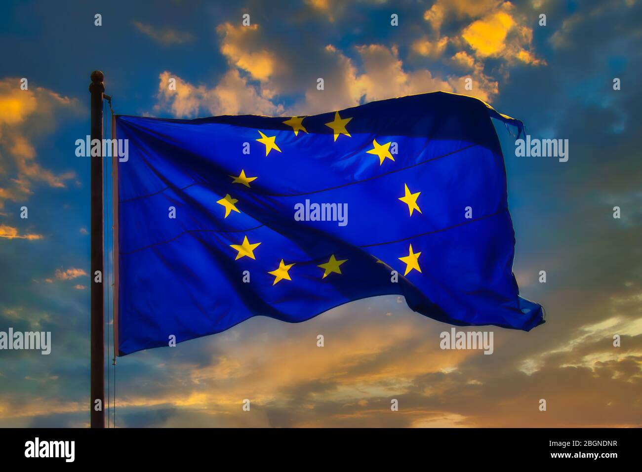 The European Union (EU) flag flies in the wind at sunset Stock Photo