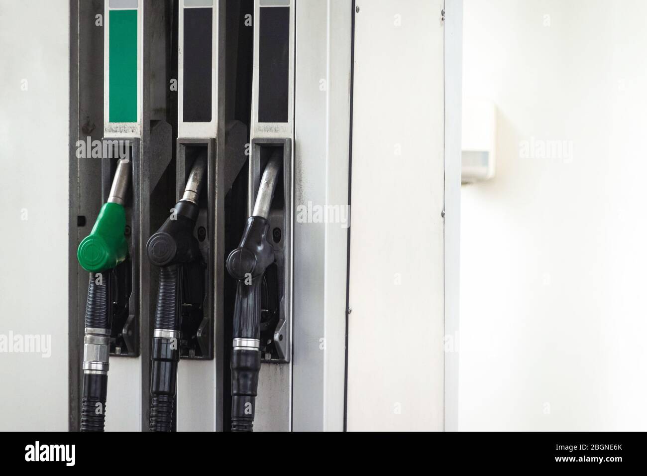 Petrol pump filling nozzles at gas station, nobody. Fuel pumps, self service Stock Photo