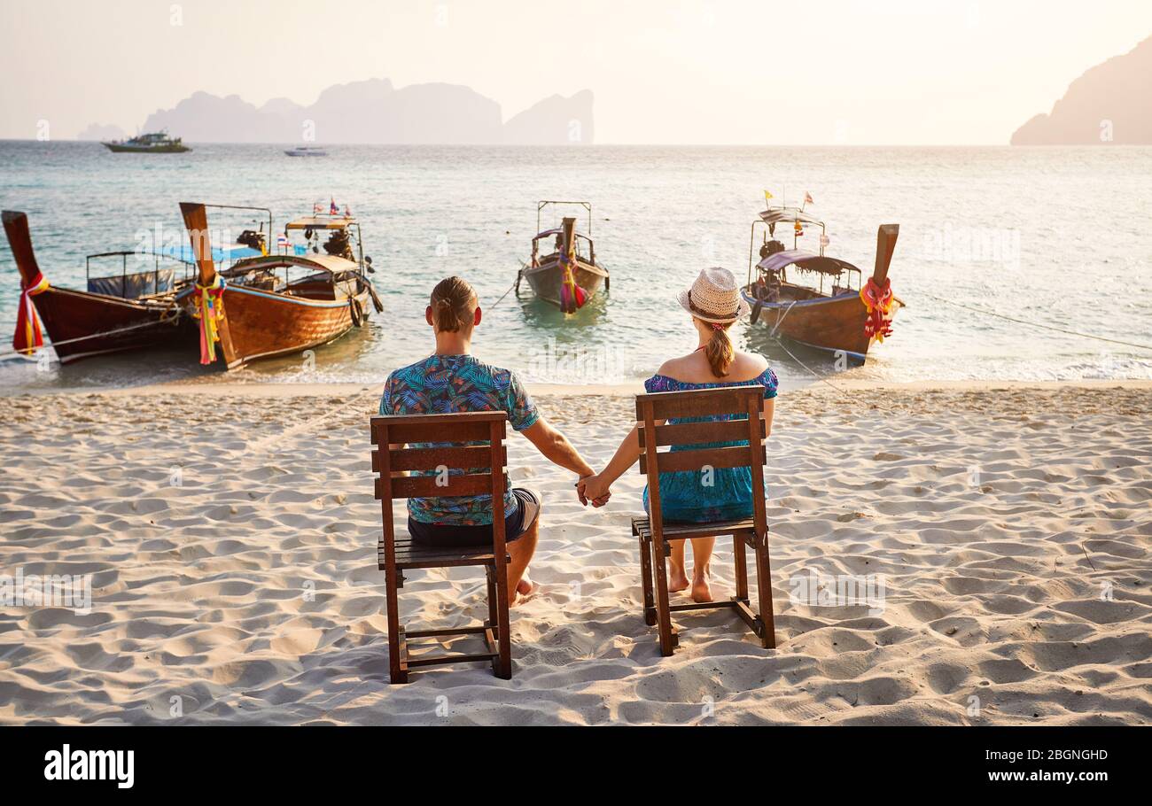 Young Couple Sitting On The Chairs On The Tropical Beach Of Phi Phi Island In Southern Thailand Travel Magazine Concept Stock Photo Alamy