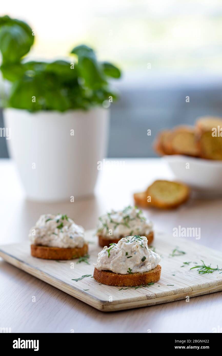 Chicken paste on baked bread and herbs Stock Photo
