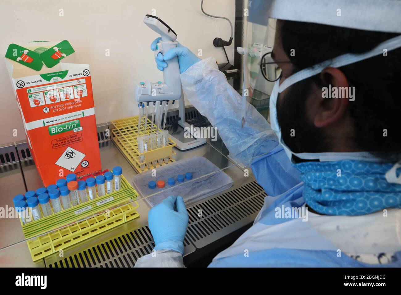 Technicians carry out a sample transfer hires stock photography and