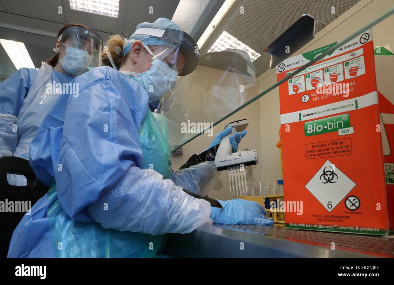 Technicians carry out a sample transfer during the opening of the new