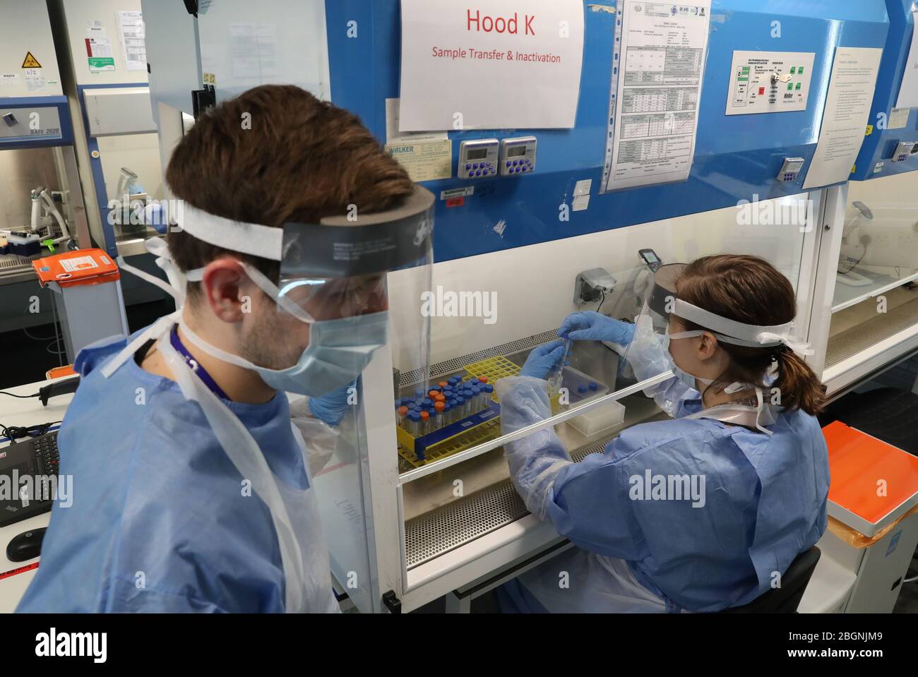 Technicians carry out a sample transfer during the opening of the new