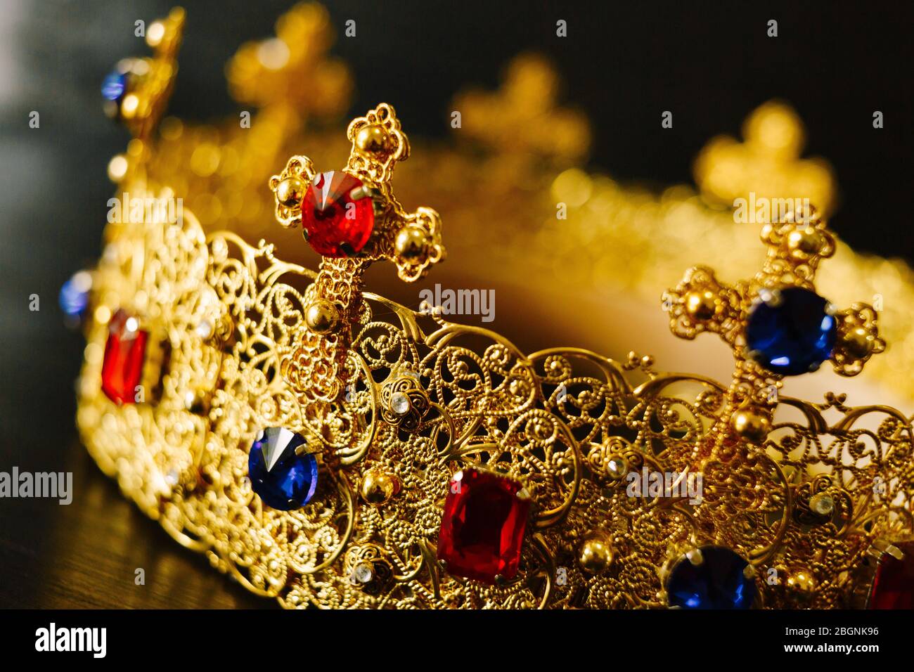 Golden crown encrusted with blue and red gemstones Stock Photo - Alamy