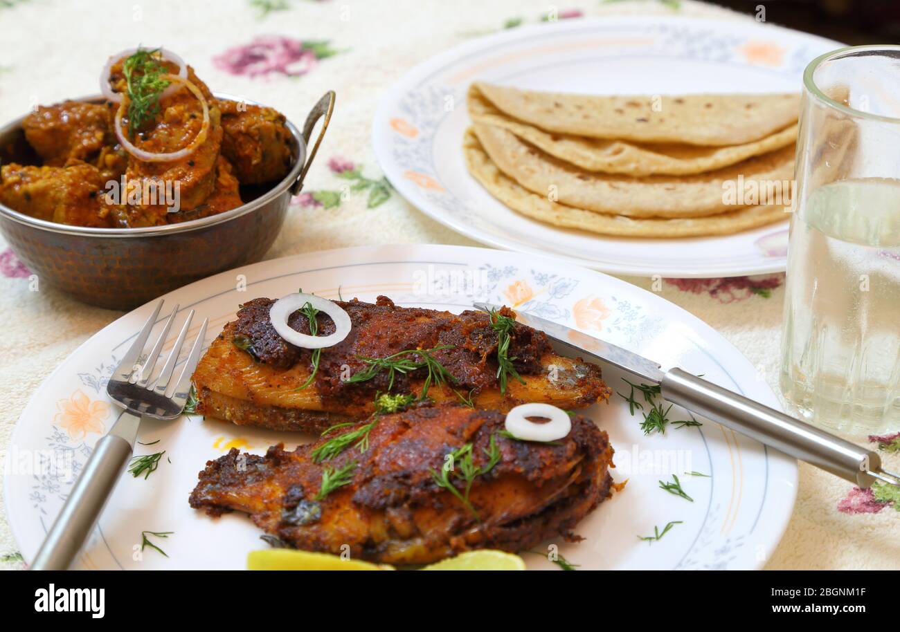 Tasty and spicy fish fry, fish curry and roti or bread from Indian cuisine. Stock Photo