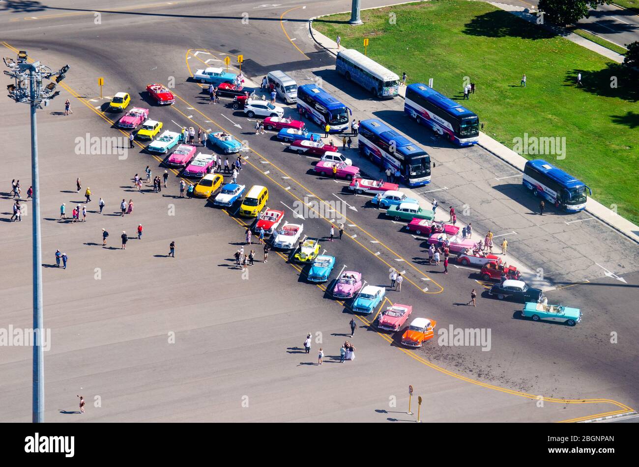 A bunch of colorful classic cars in the historical Plaza de La Revolución in La Havana waiting for tourist to rent for a ride around the city Stock Photo