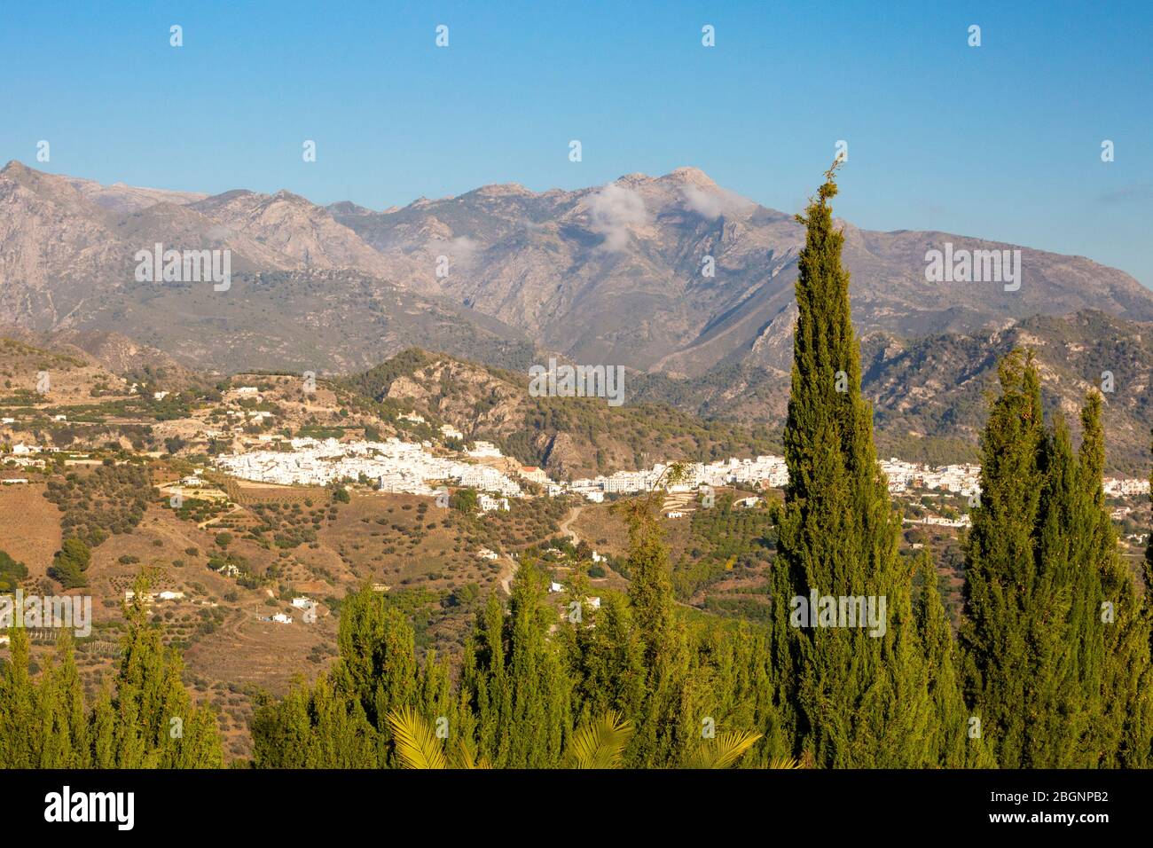 Distant view of Frigiliana with mountains in the background, Costa del Sol, Spain Stock Photo