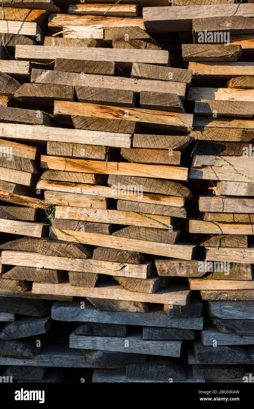 Wood stack of neatly stacked firewood and boards for drying firewood, firewood, raw material, wood rental Stock Photo