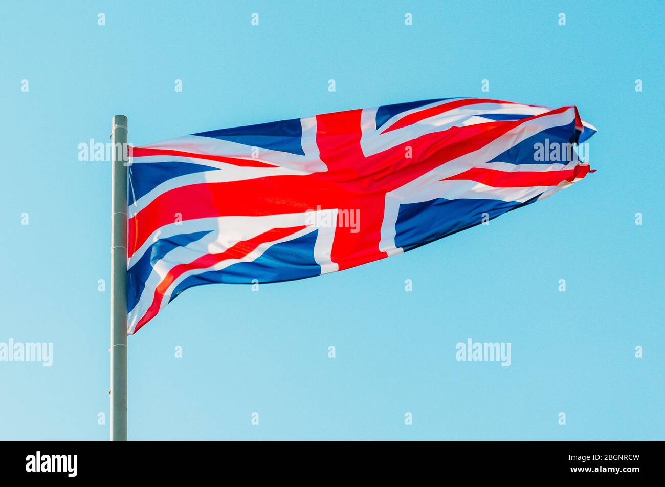 Waving colorful Great Britain flag on blue sky Stock Photo