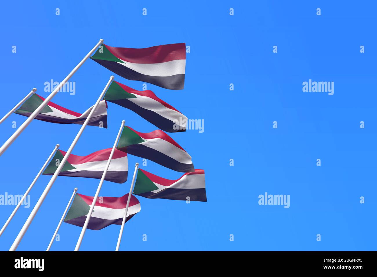 Sudan flags waving in the wind against a blue sky. 3D Rendering Stock Photo