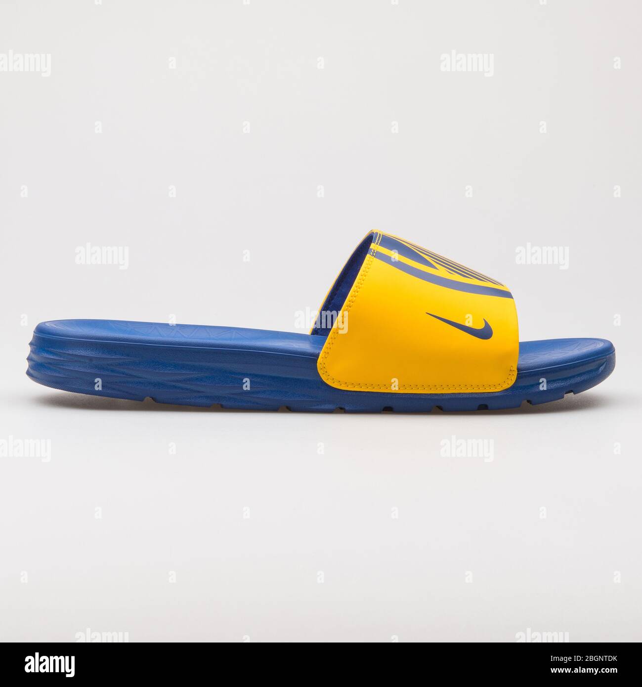 VIENNA, AUSTRIA - AUGUST 24, 2017: Nike Benassi Solarsoft NBA yellow and  blue sandal on white background Stock Photo - Alamy