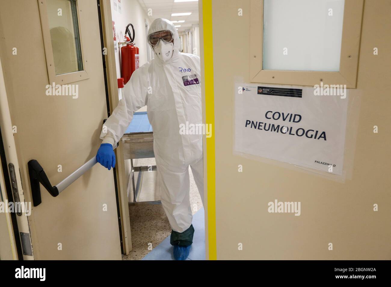 Rome, Italy. 19th Apr, 2020. A medical staffer wearing protective outfit opens the door of an Intensive Care unit's Covid-19 department at the San Filippo Neri hospital. Stock Photo